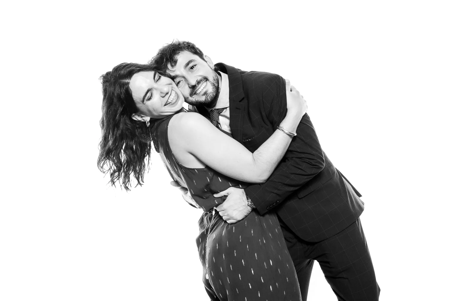 Unos invitados abrazados y sonrientes en la estación de retratos de Whitebox Portraits